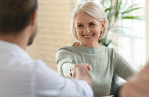 woman shaking hand with therapist